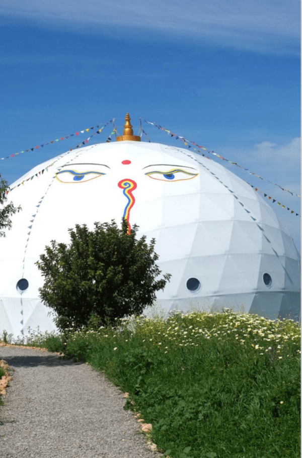 A white dome with faces painted on it.